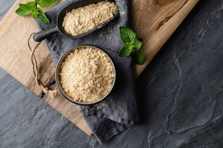 how much maca to take for hormone support - overhead view of maca powder in a bowl and spoon