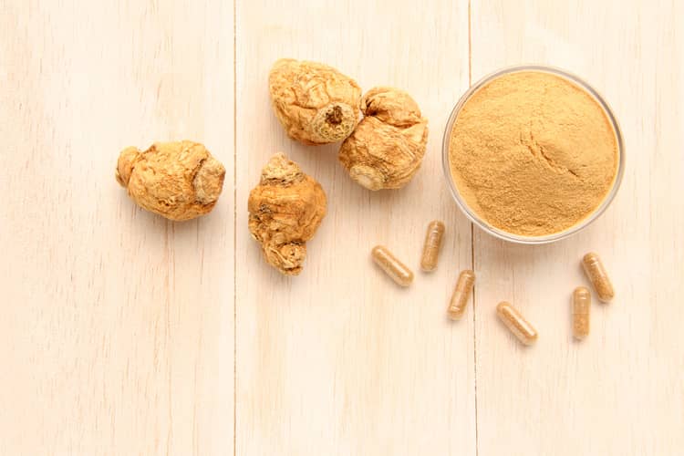 how to use maca for hormone balance - maca powder, capsules and root on a table