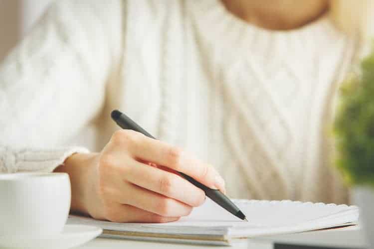 woman writing in journal