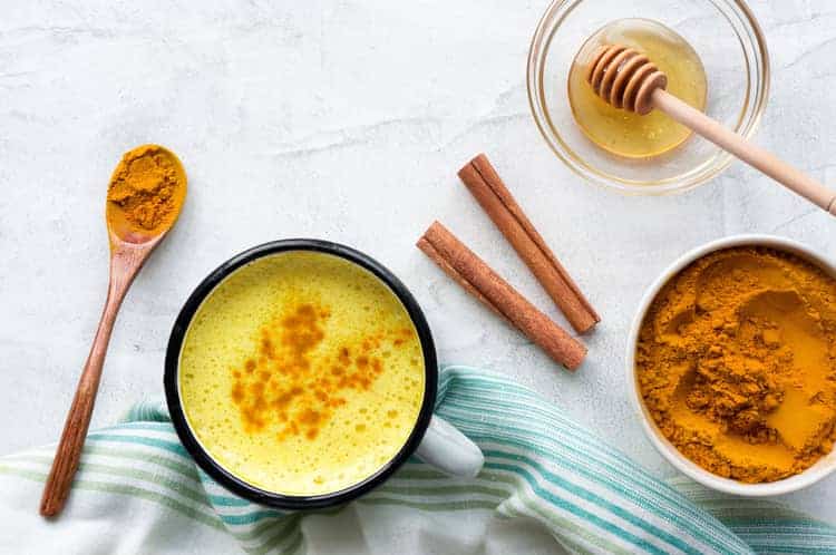 overhead view of turmeric milk and ingredients