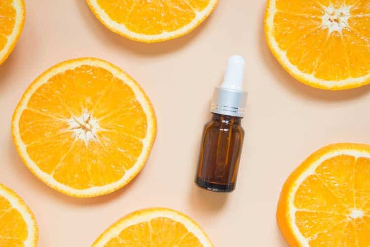 vitamin c serum surrounded by orange slices