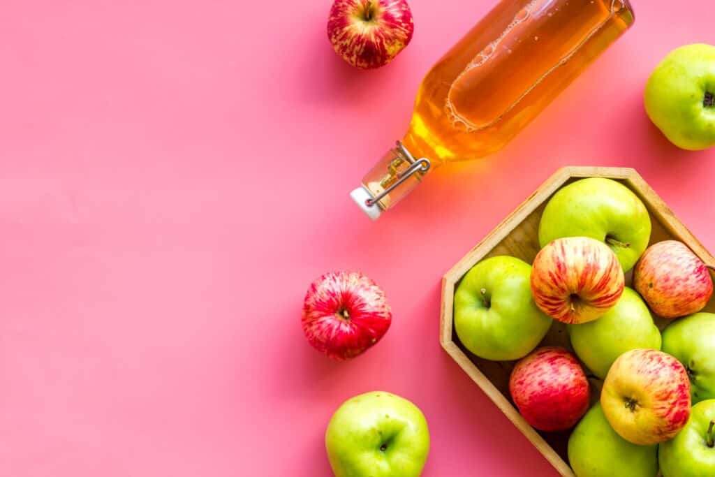 fresh apples and bottle of apple cider vinegar