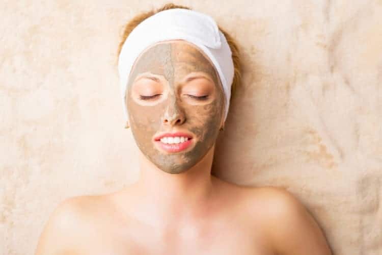 woman with clay mask on her face