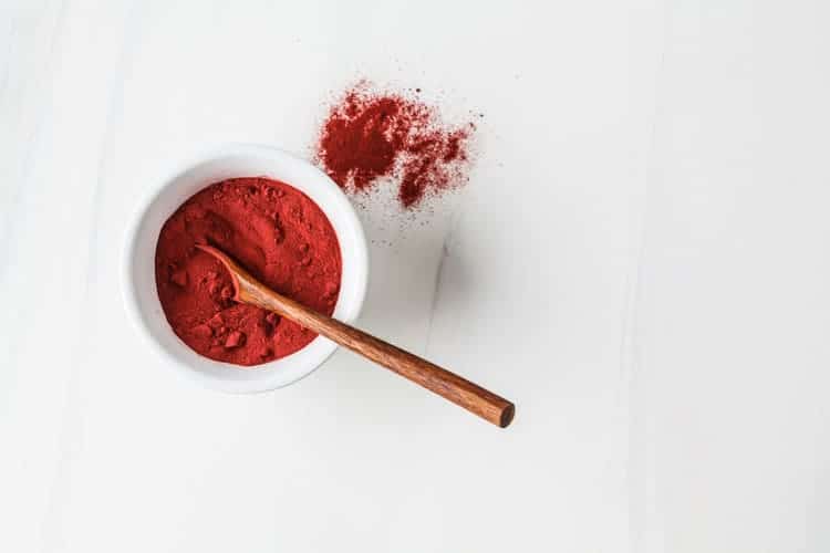 bowl of red superfood powder with spoon